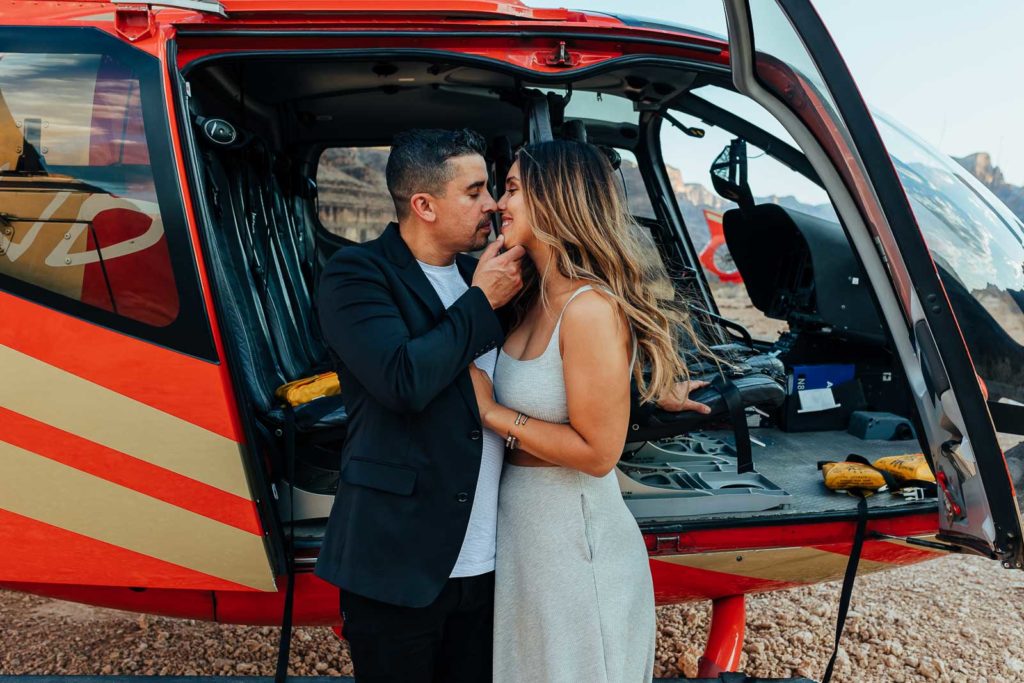 Engaged couple in front of a helicopter at the Grand Canyon