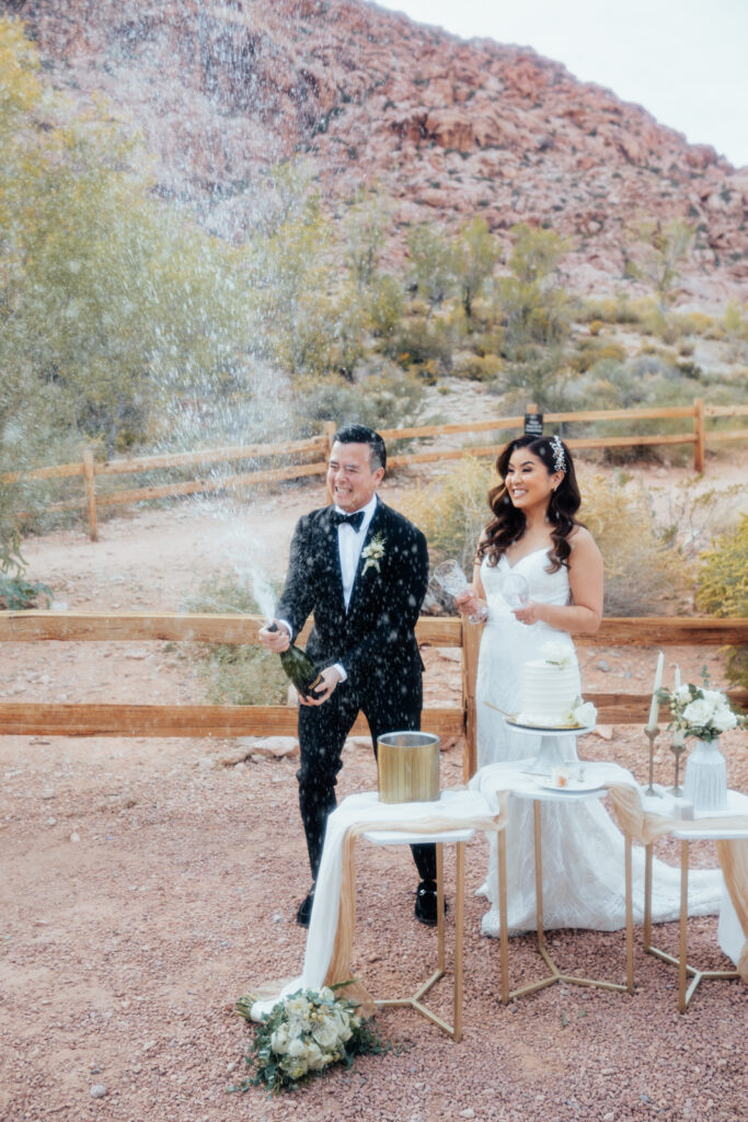 Couple popping champagne at Red Rock in Las Vegas