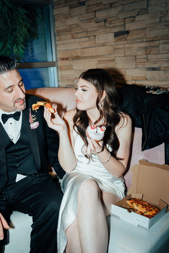Couple sharing pizza and donuts after wedding reception at Cafe Lola Las Vegas