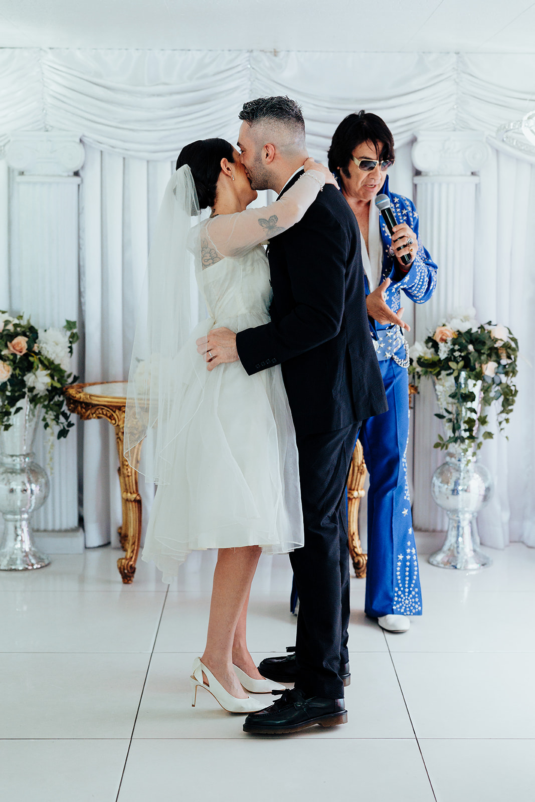 Newlyweds share their first kiss during a Las Vegas wedding at The Little White Wedding Chapel