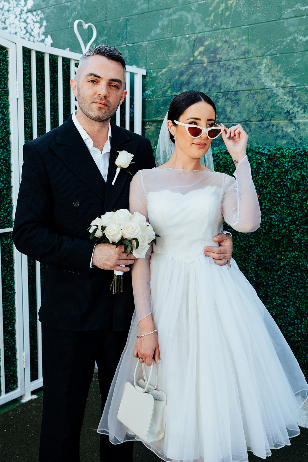 Newlyweds pose for portraits outside The Little White Wedding Chapel in Las Vegas