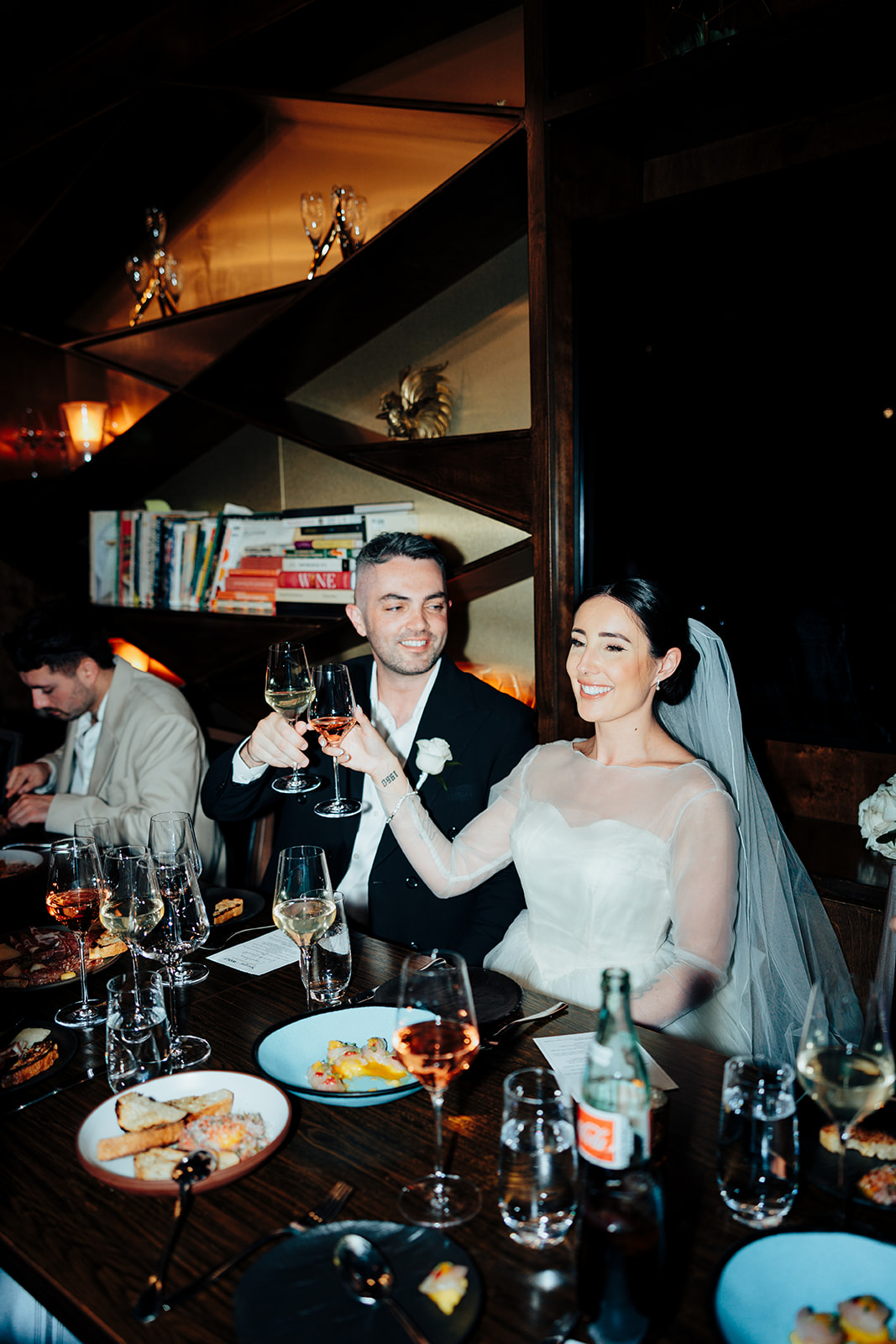 Newlyweds raise glasses during intimate reception dinner in Las Vegas