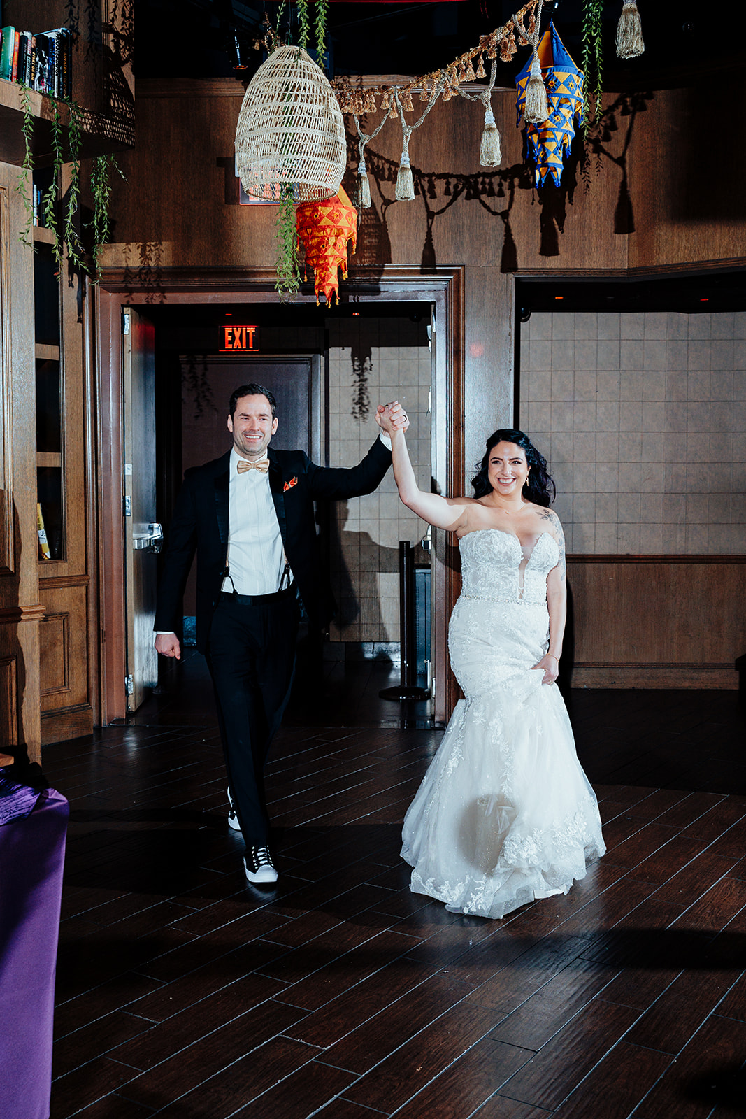 Bride and Groom Entering Reception Holding Hands