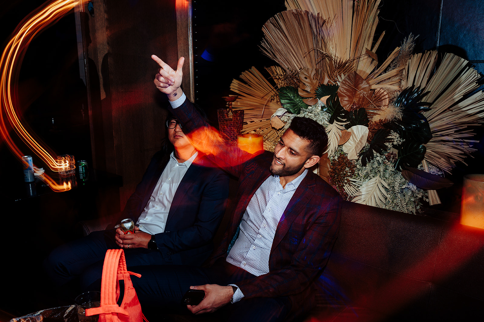 Wedding Guests Enjoying Lounge Area Amid Vibrant Lights