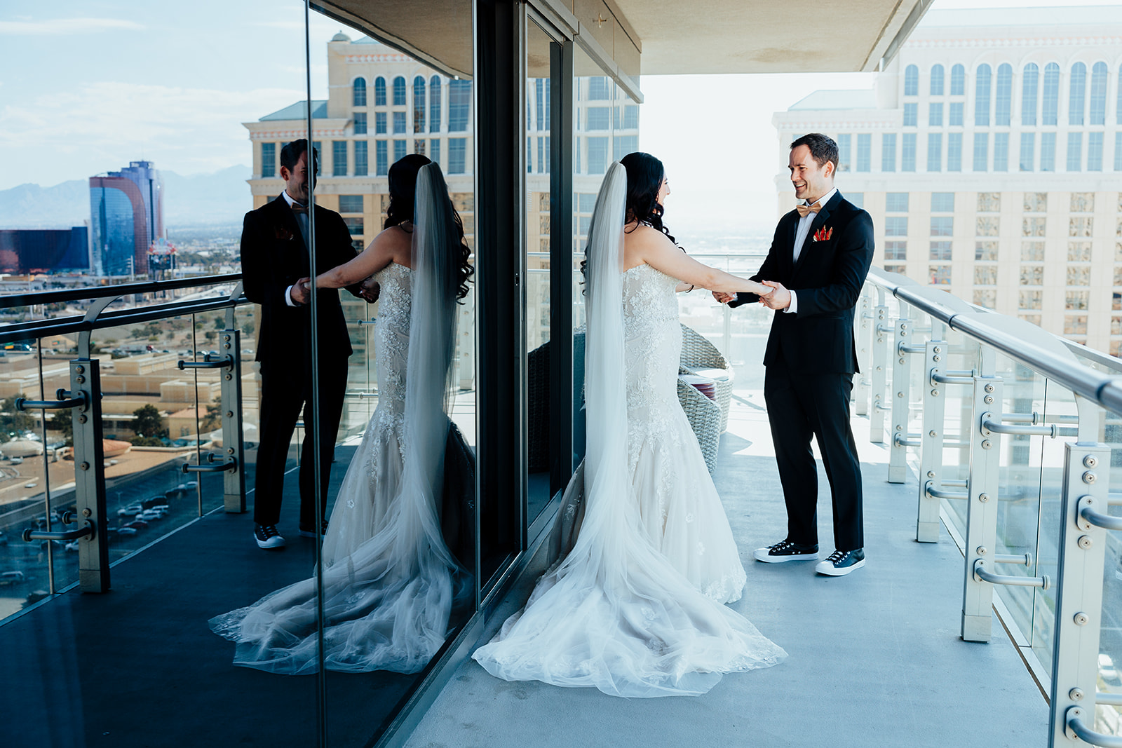 Couple holding hands during first look on Las Vegas balcony