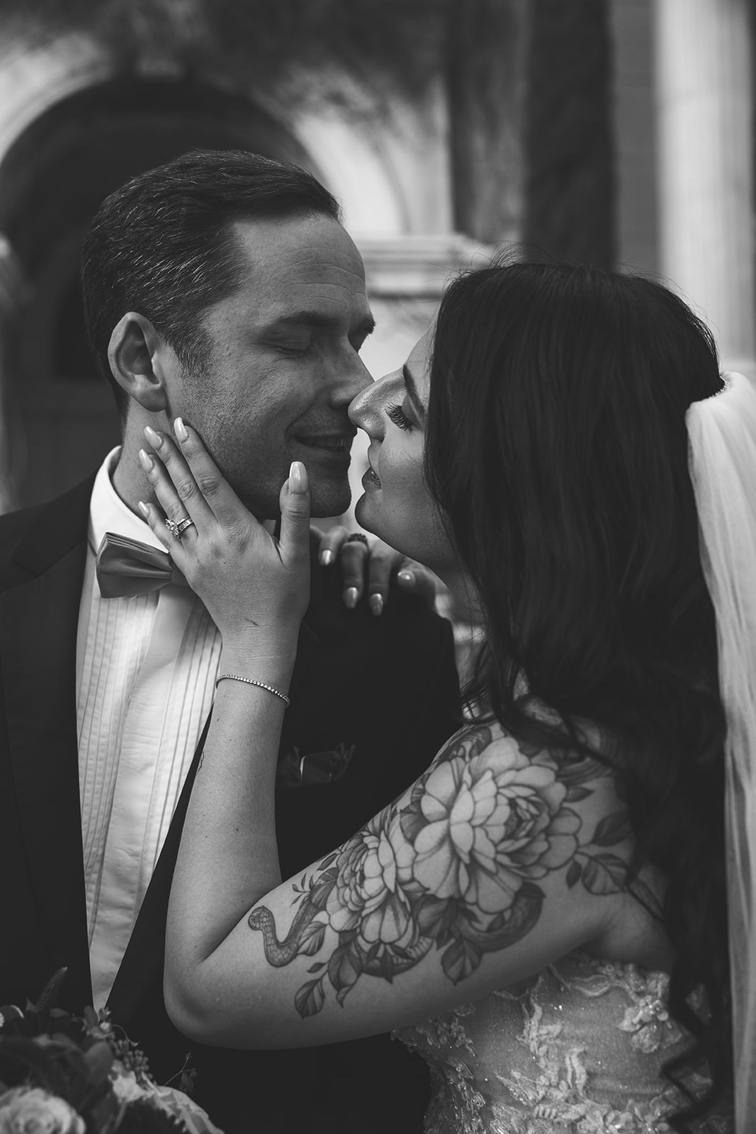 Black-and-white close-up of bride and groom sharing a romantic moment