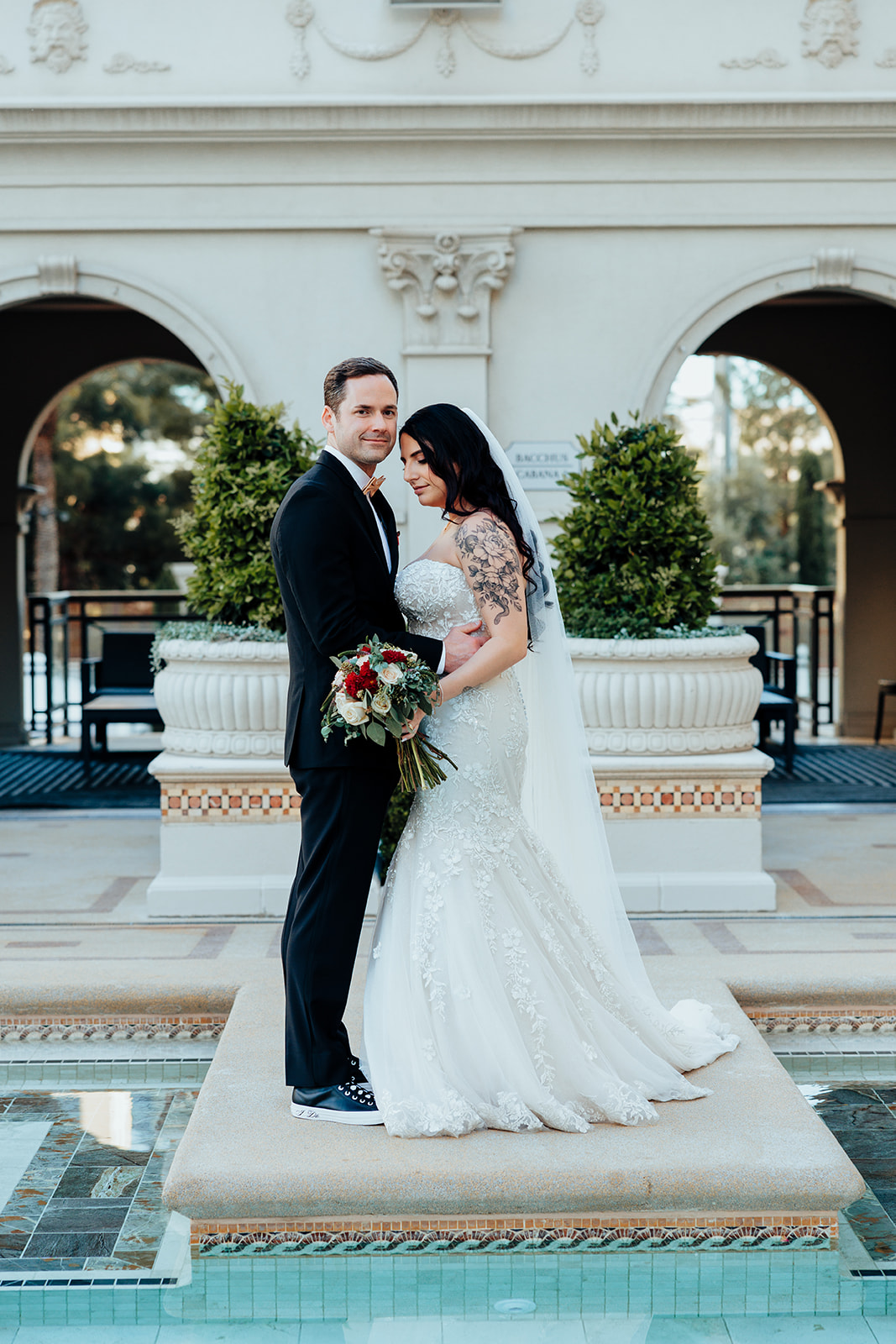 Couple posing near fountain at Caesars Palace in Las Vegas wedding