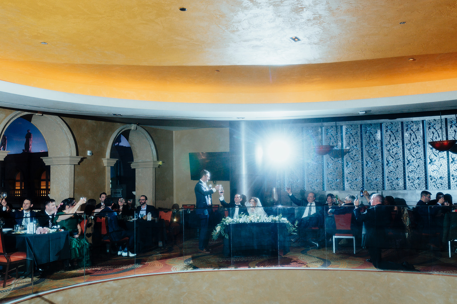 Best man giving a heartfelt toast to the bride and groom at their Las Vegas wedding reception, surrounded by guests at Caesars Palace.