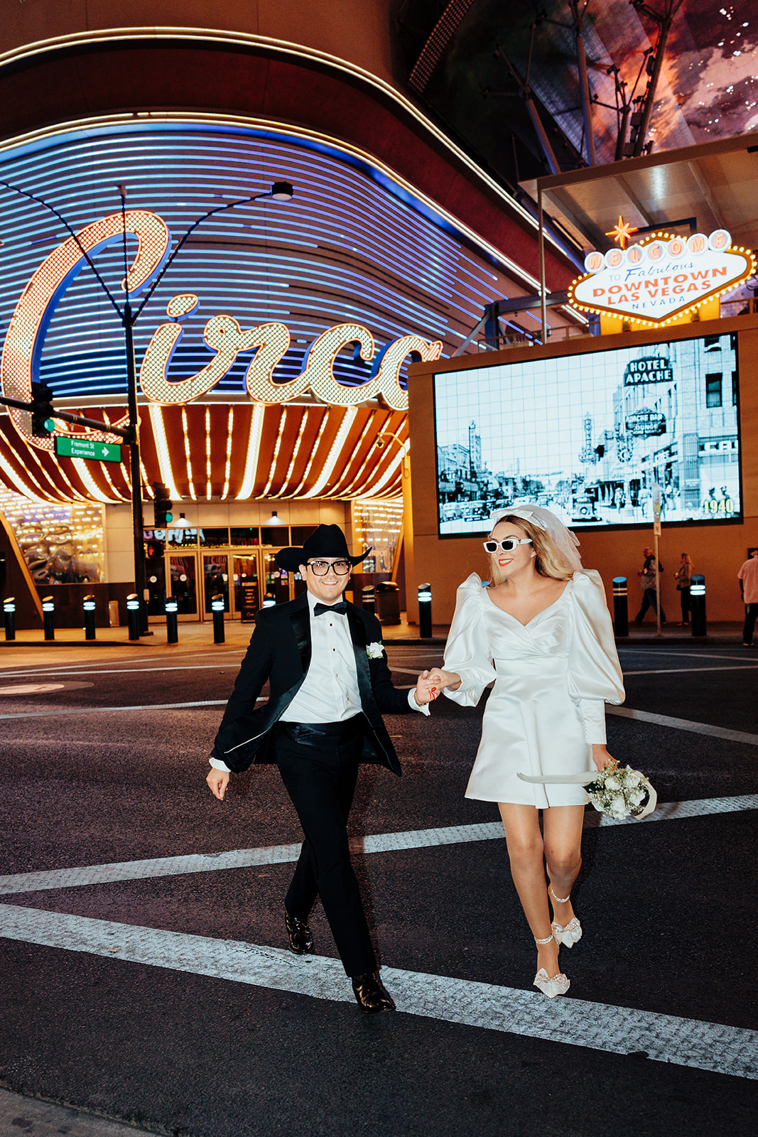 Bride and Groom Holding Hands in Front of Circa Casino