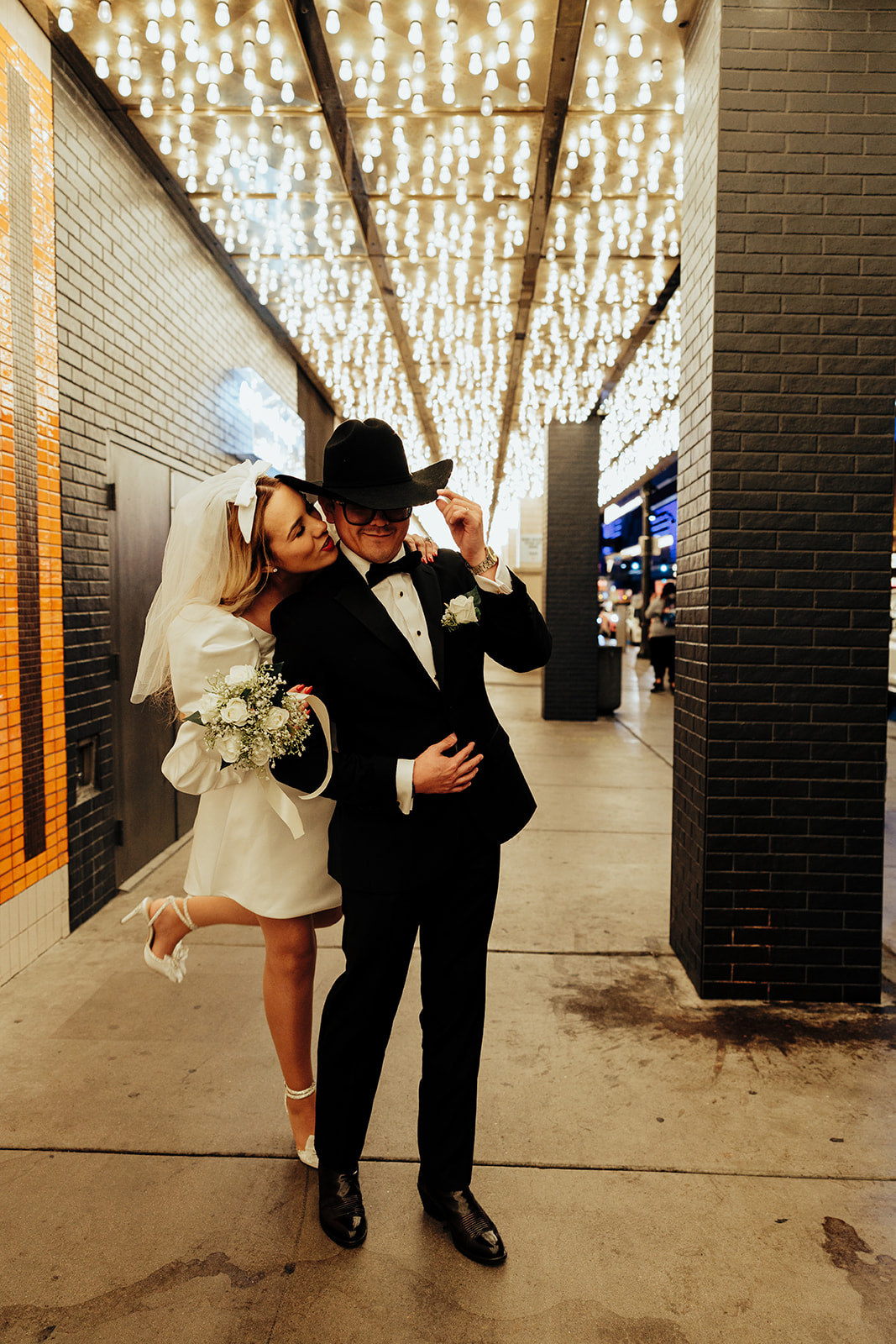 Bride Kisses Groom’s Shoulder Under Vegas Neon Lights