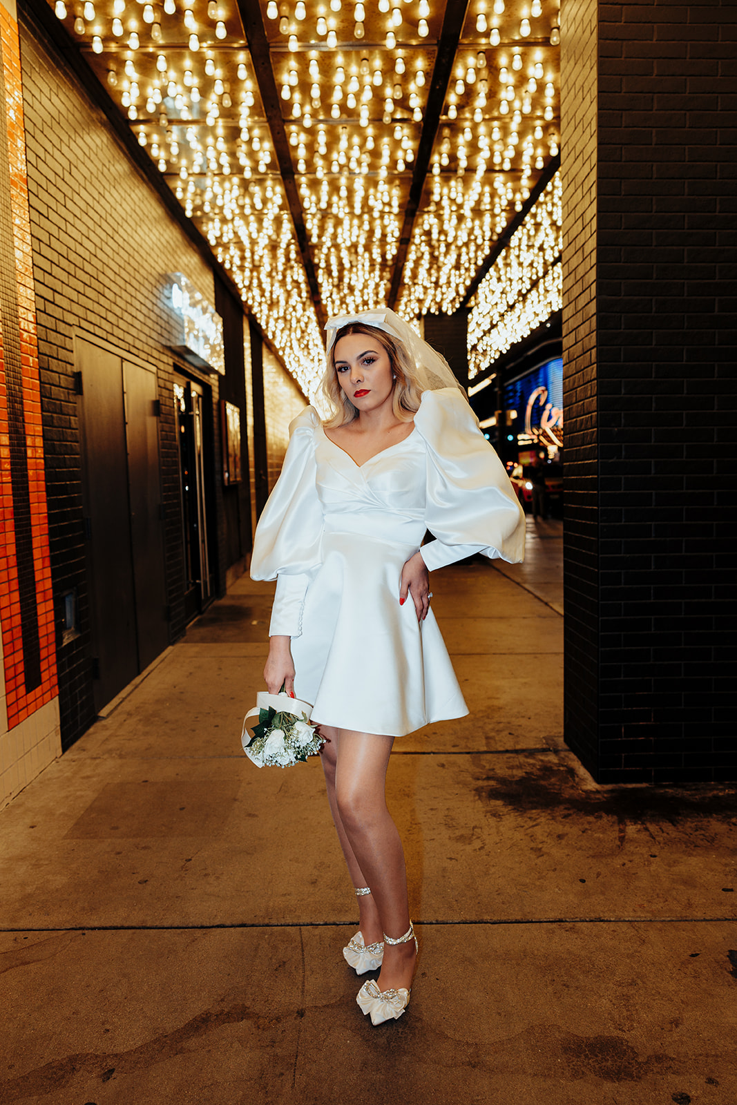 Stylish Bride in Short Wedding Dress Holding Bouquet