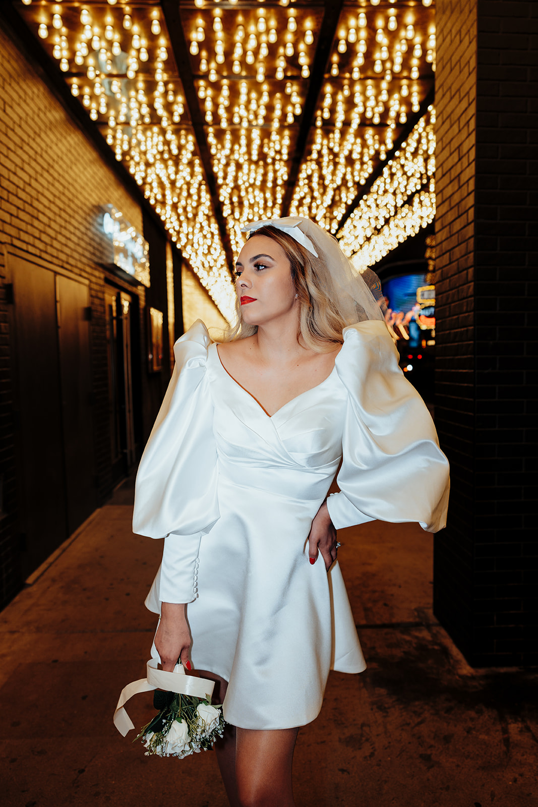 Bride Holding Bouquet Under Neon Lights in Las Vegas