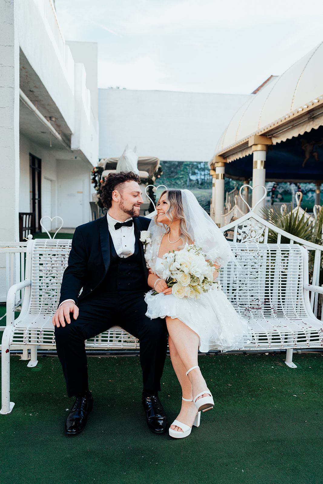 Couple sitting on white bench during Little White Wedding Chapel elopement in Las Vegas