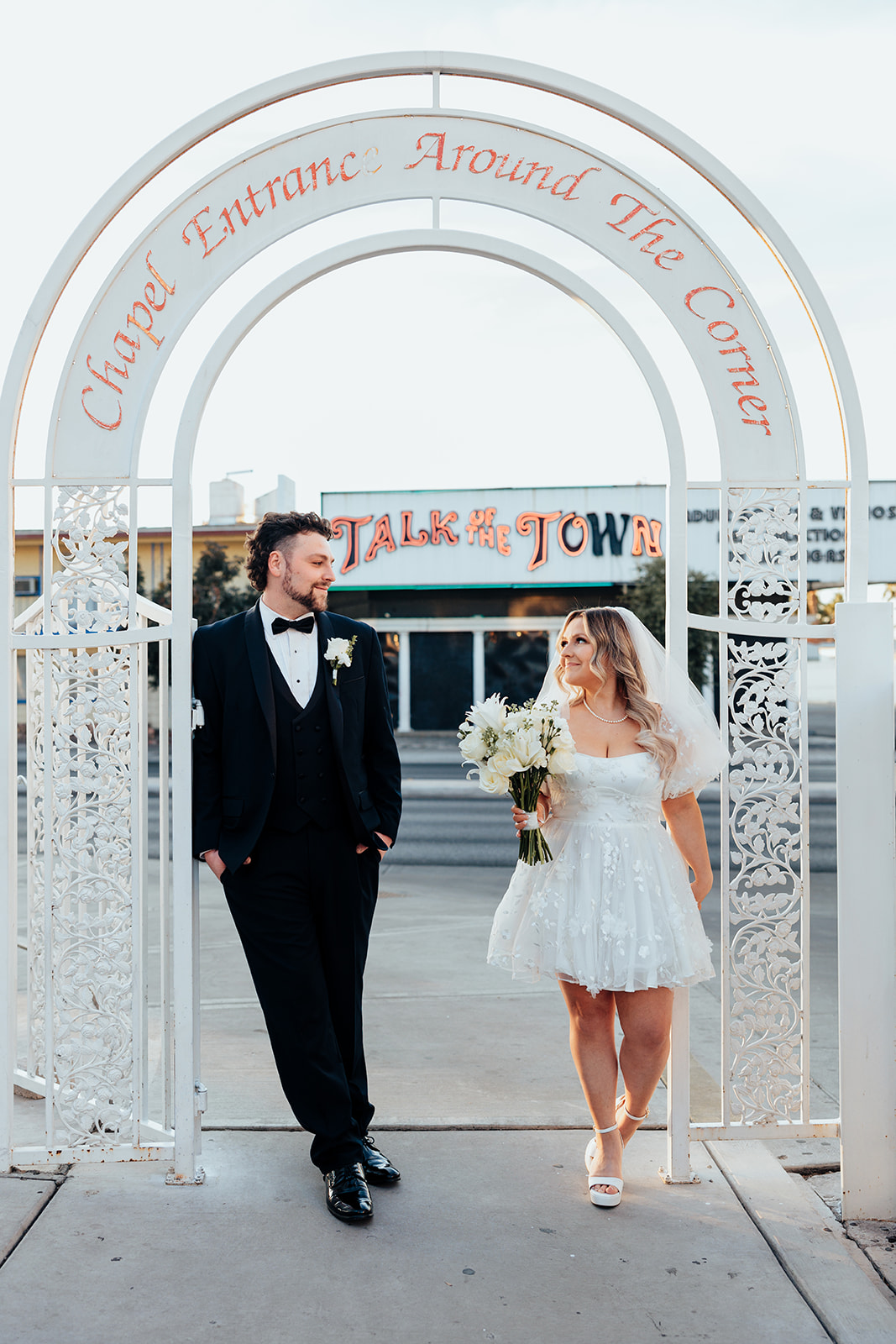 Couple under chapel entrance arch during Little White Wedding Chapel elopement in Las Vegas