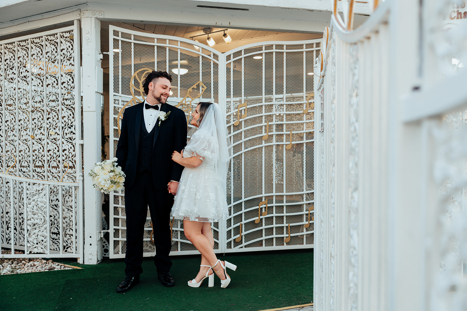 Couple standing together near chapel entrance during Little White Wedding Chapel elopement