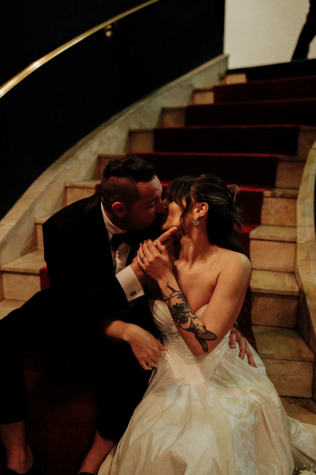 A couple kissing on the stairs of the El Cortez Hotel in Las Vegas Nevada.