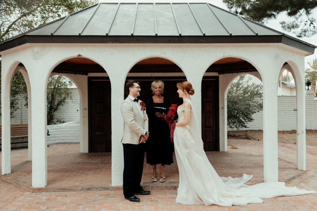 Couple having wedding reception in front of arches in the pool oasis