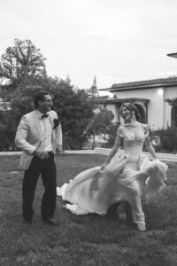 couple running in the grass at Desert Inn Oasis