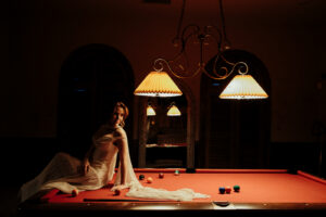 bride on the pool table in dark and moody lighting