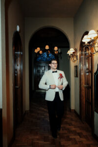 Groom walking through the hallway at night